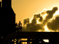 At sunrise a worker performs maintainance at a California steam energy plant.